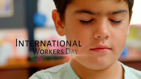 Animation-of-caucasian-boy-and-international-workers-day-text