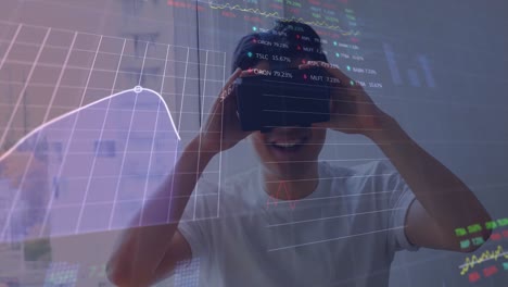 Animation-of-financial-and-stock-market-data-processing-over-asian-man-wearing-vr-headset
