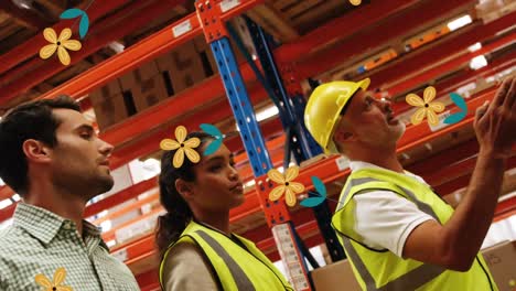 Animation-of-falling-flowers-over-diverse-group-of-warehouse-workers