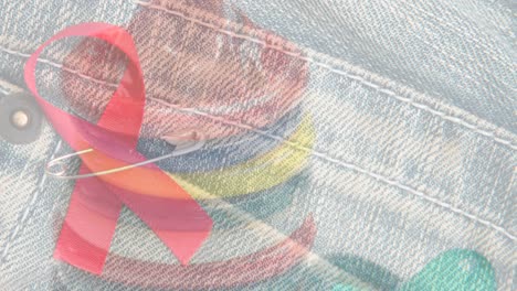 Animation-of-jeans-with-red-ribbon-over-condoms-on-white-background