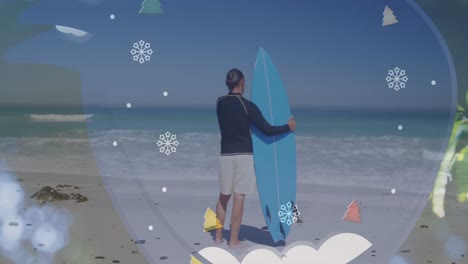 Animation-of-snowflakes-and-trees-over-back-view-of-caucasian-male-surfer-on-beach