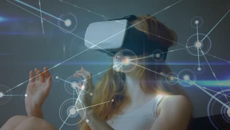 Animation-of-data-processing-over-caucasian-woman-using-vr-headset
