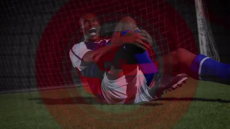Animation-of-globe-over-african-american-male-soccer-player-having-contusion-during-game