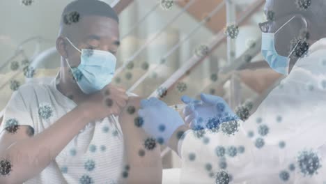 Animation-of-virus-cells-over-african-american-male-doctor-in-face-mask-vaccinating-boy