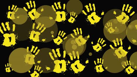 Animation-of-yellow-hand-prints-and-dots-over-black-background