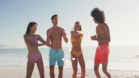 Animation-of-hearts-floating-over-happy-diverse-female-and-male-friends-having-fun-on-beach