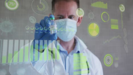 Animation-of-virus-cells-and-data-over-caucasian-male-doctor-in-face-mask-holding-vaccine