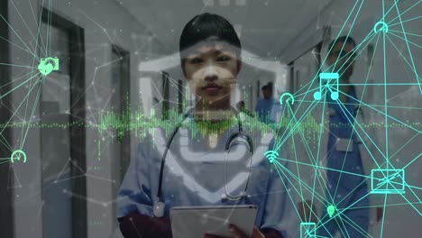 Animation-of-network-of-connections-and-digital-padlock-over-asian-female-doctor