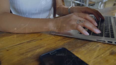 Animation-of-connections-over-hands-of-biracial-woman-using-laptop
