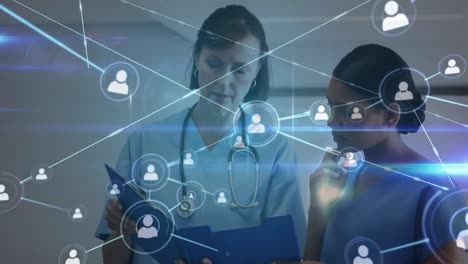 Animation-of-network-of-connections-with-icons-over-diverse-doctors-in-hospital