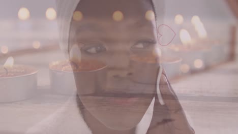 Animation-Von-Herzsymbolen-Und-Kerzen-über-Einer-Afroamerikanerin,-Die-Ihr-Gesicht-Wäscht