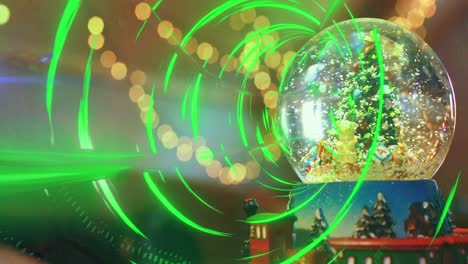 Animation-of-light-spots-over-snow-globe-with-christmas-tree
