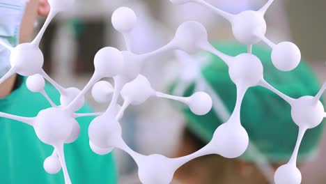 Animation-of-molecules-over-caucasian-doctors-during-surgery