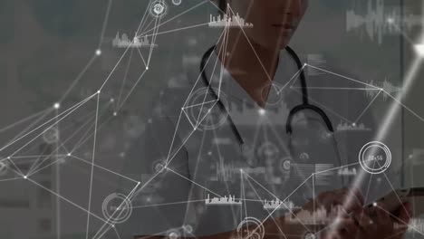 Animation-of-network-of-connections-over-indian-female-doctor-using-digital-tablet