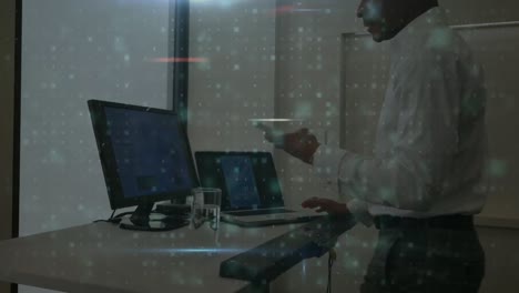 Animation-of-scanning-over-african-american-man-working-with-computers