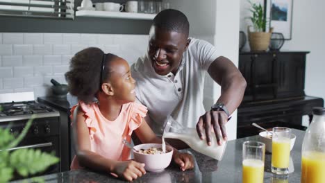 Video-of-african-american-father-and-daughter-eating-breakfast