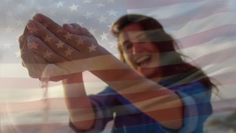 Animation-of-waving-usa-flag-over-caucasian-women-on-the-beach