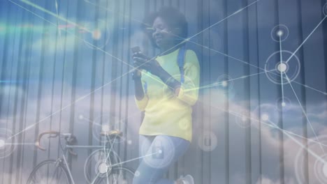 Animation-of-network-of-connections-over-clouds-and-african-american-woman-with-smartphone-and-bike