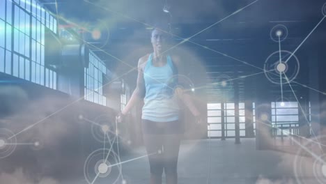 Animation-of-network-of-connections-over-clouds-and-fit-afrcian-american-woman-jumping