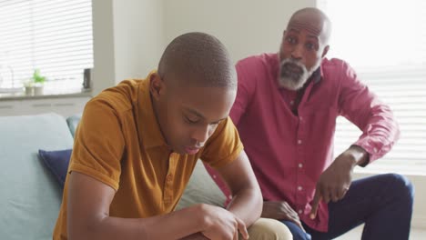 Video-of-nervous-african-american-father-yelling-on-son-at-home