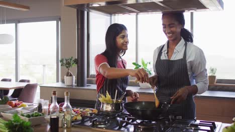 Video-of-happy-diverse-female-friends-preparing-meal