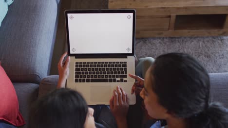 Video-of-happy-diverse-female-friends-using-laptop-with-copy-space