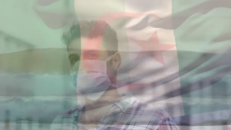 Animation-of-flag-of-algeria-over-biracial-man-in-face-mask