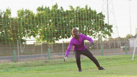 Video-of-african-american-goalkeeper-on-field,-playing-football