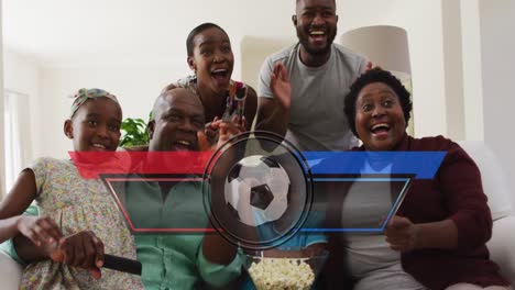 Animation-of-ball-and-team-colours-over-happy-african-american-family-watching-match