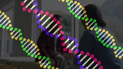 Animation-Von-DNA-Strängen-über-Einer-Asiatischen-Physiotherapeutin,-Die-Mit-Einem-Patienten-Spricht