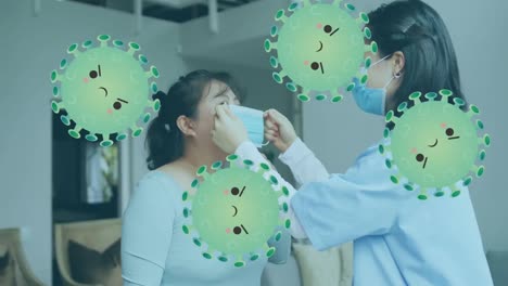 Animation-of-virus-cells-over-asian-female-doctor-and-patient-wearing-face-masks