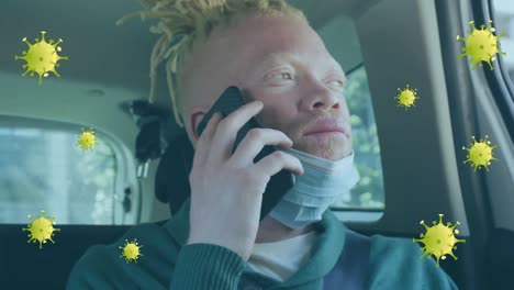 Animation-of-virus-cells-over-albino-african-american-man-using-smartphone