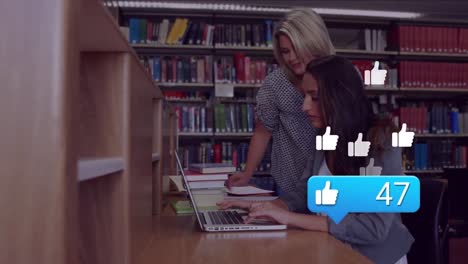 Animation-of-falling-social-media-icons-over-two-caucasian-students-using-laptop