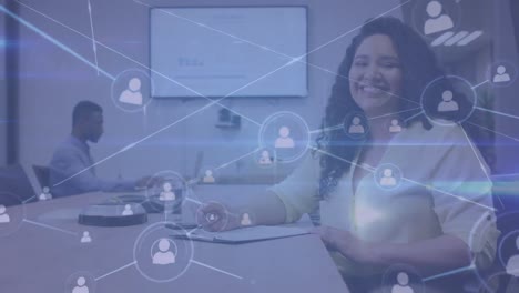 Animation-of-connections-with-digital-icons-over-smiling-biracial-businesswoman-in-office