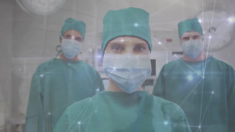 Animation-of-network-of-connections-over-caucasian-female-and-male-surgeons-looking-at-camera