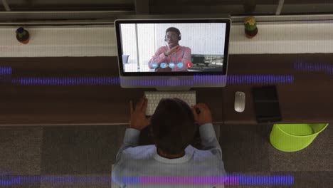 Animation-of-interference-over-african-american-businessman-using-laptop-for-video-call
