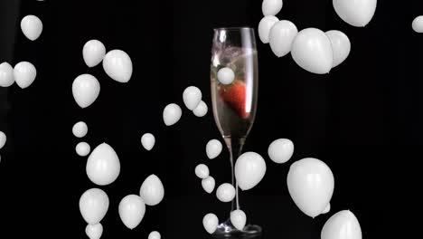 Animation-of-white-balloons-over-glass-of-champagne-on-black-background