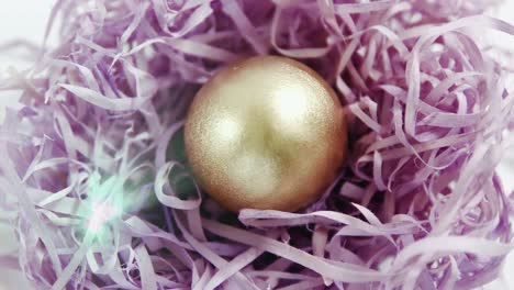 Animation-of-gold-bauble-in-violet-straw