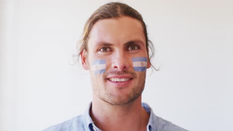 Image-of-happy-caucasian-man-with-flag-of-argentina-looking-at-camera