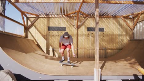 Video-of-caucasian-male-skateboarder-training-in-skate-park