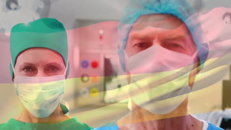 Animation-of-flag-of-germany-over-caucasian-female-and-male-doctors-in-face-masks