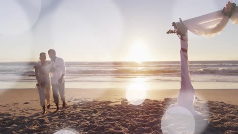 Animation-of-dots-over-happy-african-american-newly-married-couple-on-beach
