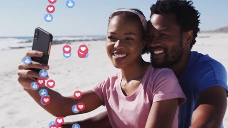 Animation-of-media-icons-over-african-american-couple-using-smartphone