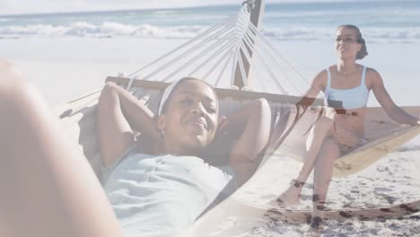 Animation-of-happy-african-american-woman-in-hammock-on-beach
