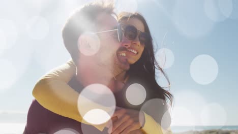 Animation-of-dots-over-happy-caucasian-couple-having-fun-on-beach