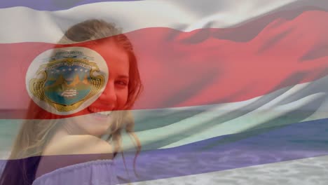 Animation-of-flag-of-costa-rica-over-caucasian-woman-at-beach