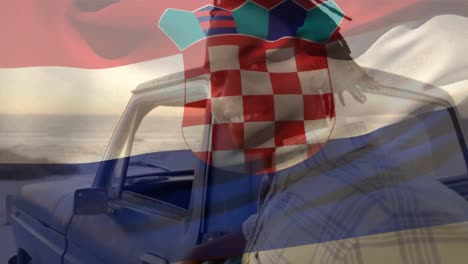 Animation-of-croatia-flag-waving-over-portrait-of-african-american-man-standing-by-pick-up-truck
