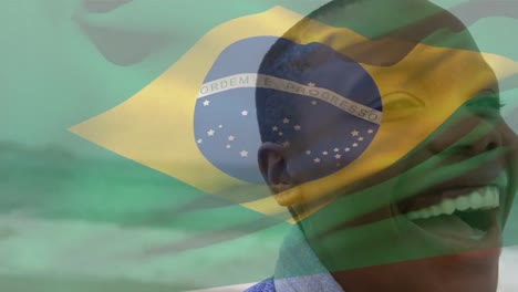 Animation-of-flag-of-brazil-over-african-american-woman-at-beach