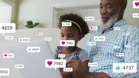 Animation-of-icons-with-growing-number-over-african-american-man-and-his-granddaughter-using-laptop