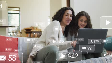 Animation-of-icons-with-growing-number-over-biracial-woman-and-her-daughter-using-laptop